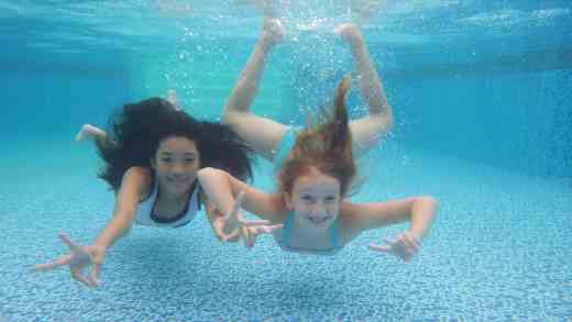 Swimmers Underwater in Pool